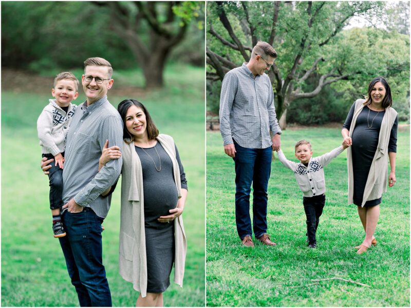 A smiling family with a pregnant mom, dad, and young son poses for a maternity session in a green, tree-filled park.