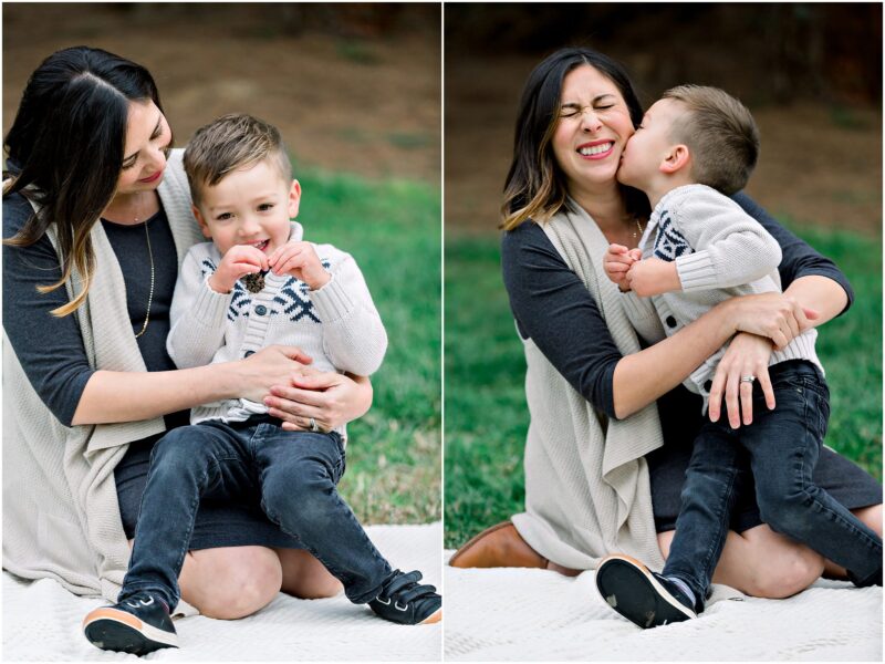 A woman sits on a blanket outdoors, laughing as a young boy hugs her during their Solana Beach maternity session.