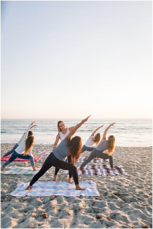 Yoga teacher leading a yoga class on the beach