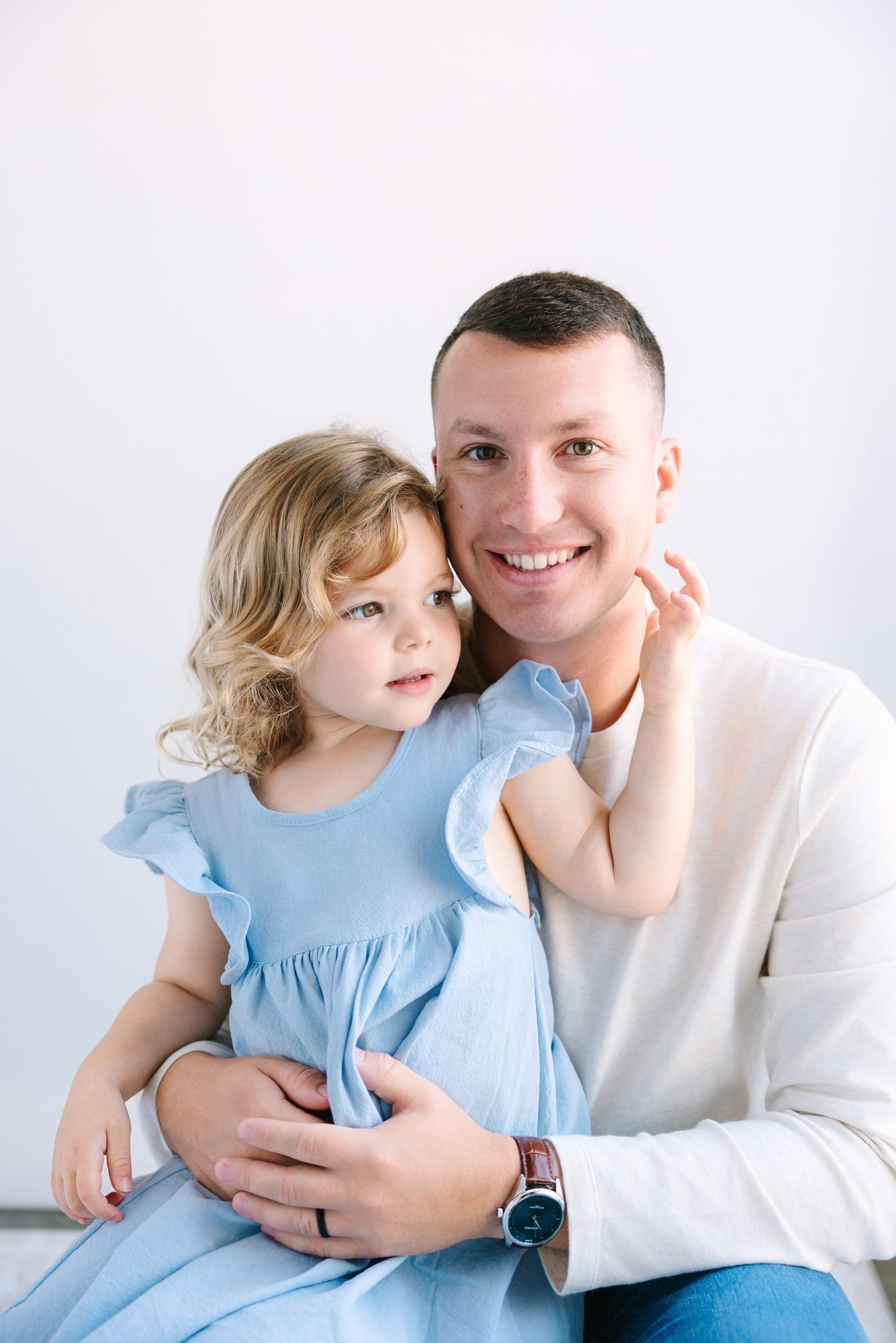 Father with his young daughter on his lap in the Carlsbad studio