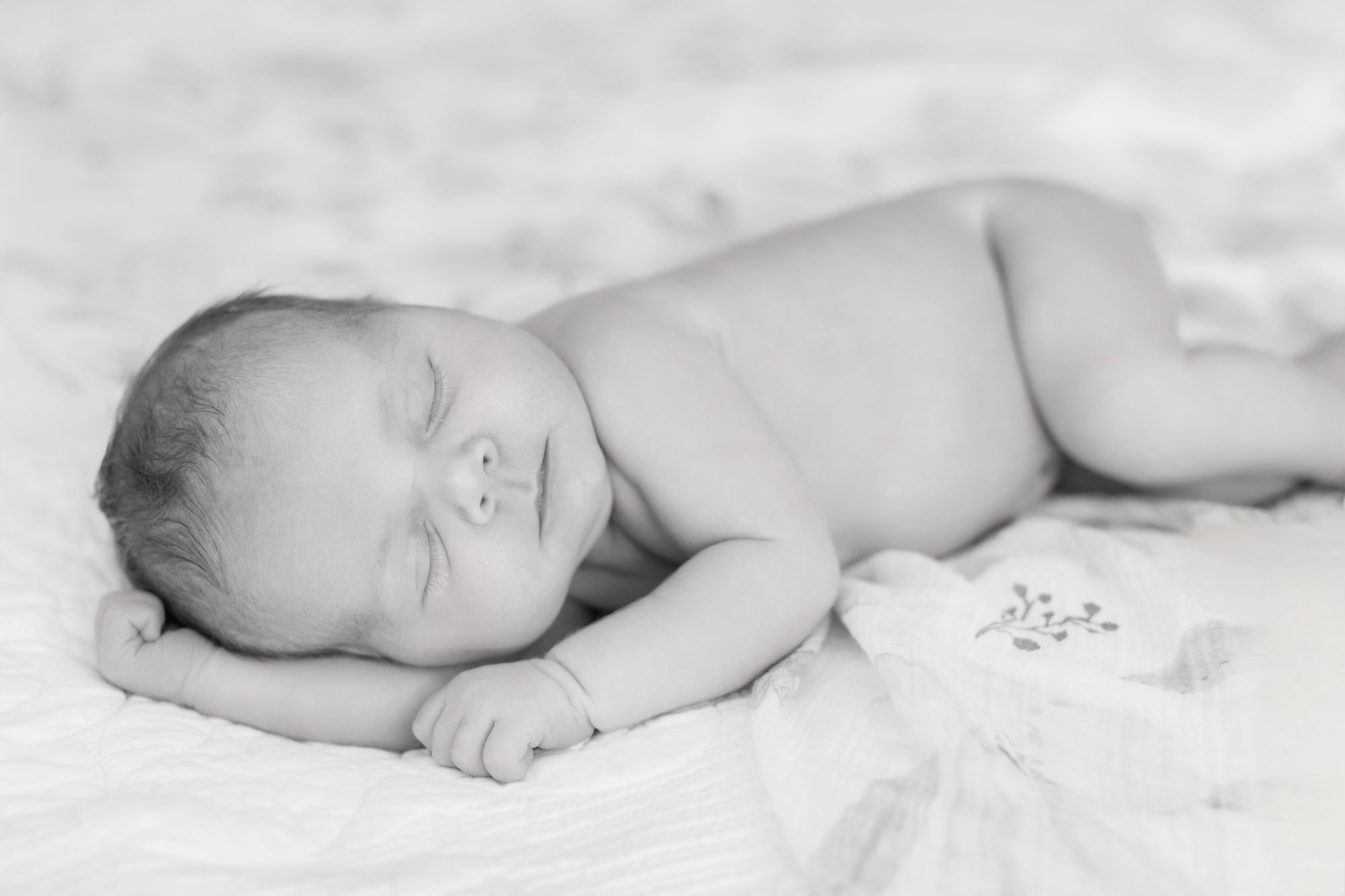 Peaceful newborn in soft blanket during Carlsbad studio newborn photoshoot